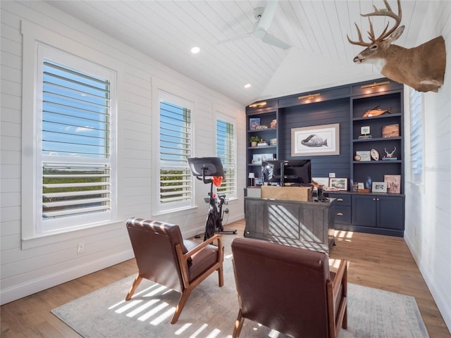 office space featuring built in shelves, ceiling fan, light hardwood / wood-style flooring, lofted ceiling, and wood ceiling