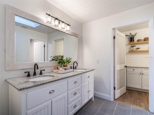 bathroom with vanity and wood-type flooring