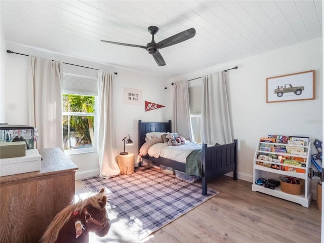 bedroom with light hardwood / wood-style flooring, ceiling fan, and wooden ceiling