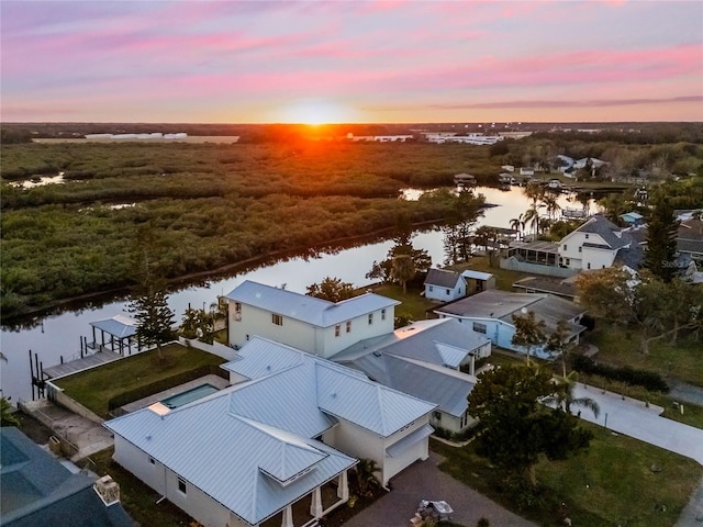 aerial view at dusk with a water view