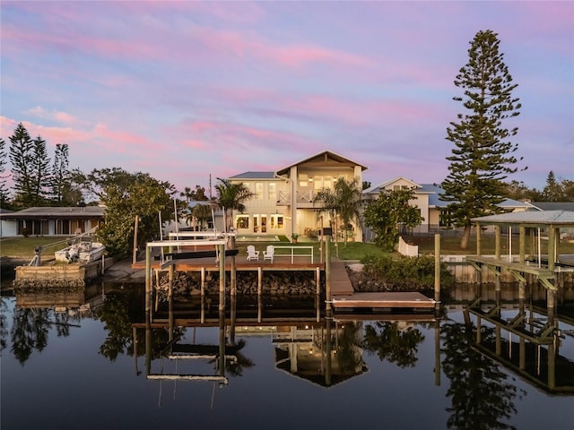 view of dock featuring a balcony and a water view