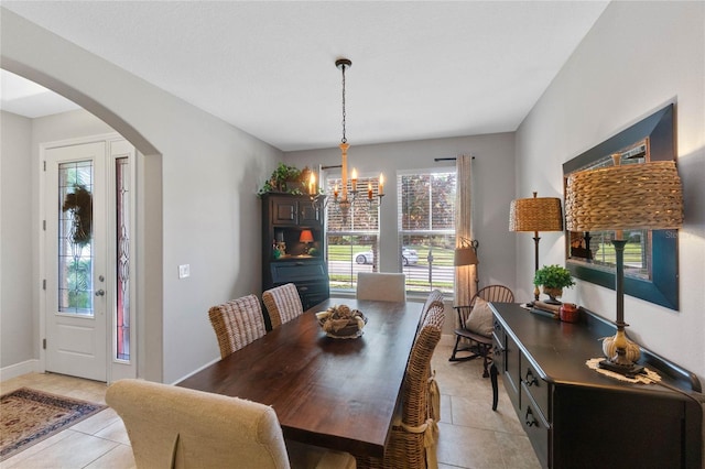 tiled dining area with plenty of natural light and a chandelier