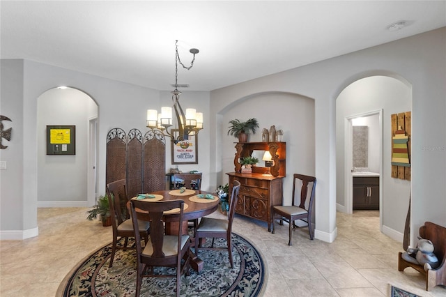 tiled dining area with a chandelier