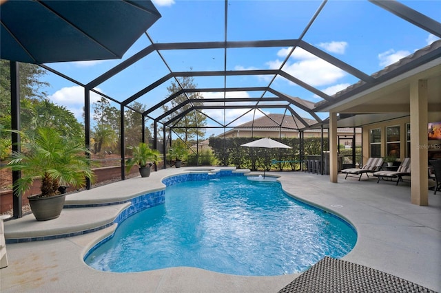 view of swimming pool featuring a patio area and a lanai