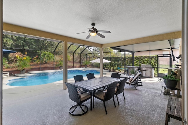 view of swimming pool with glass enclosure, ceiling fan, a patio area, and a grill