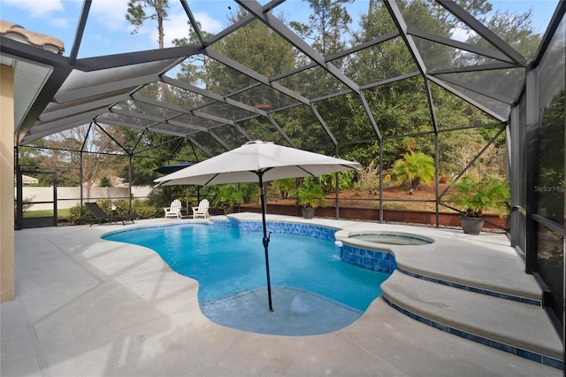 view of pool featuring a patio area, an in ground hot tub, and glass enclosure