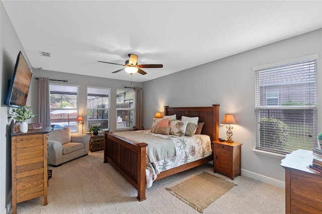 bedroom with ceiling fan and light carpet