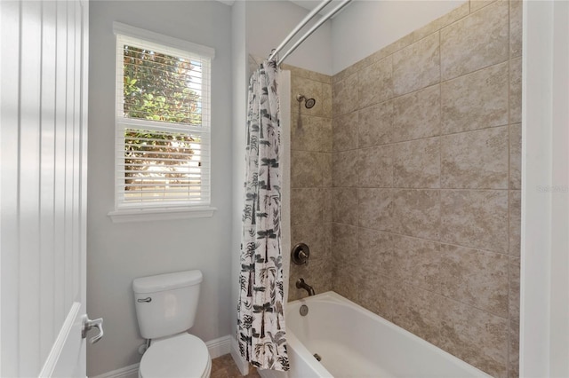 bathroom featuring toilet and shower / tub combo with curtain