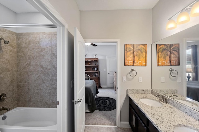 bathroom featuring vanity, tiled shower / bath combo, and ceiling fan