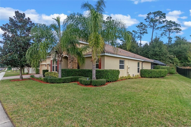 view of side of home featuring a lawn and a garage