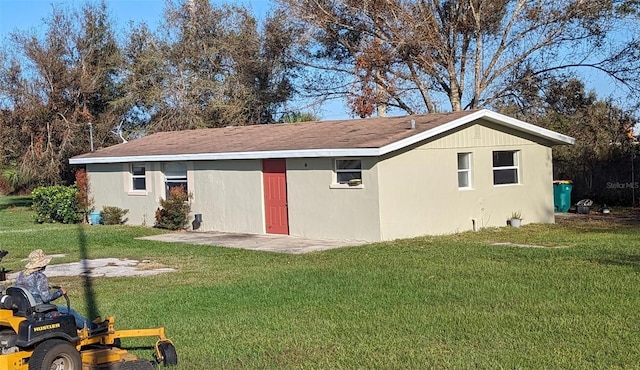 rear view of property featuring a lawn and a patio