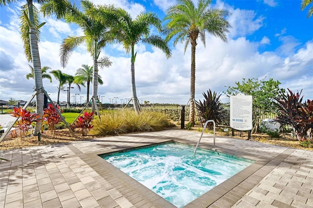 view of swimming pool with a community hot tub