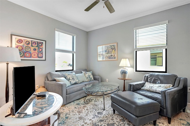 living room with ornamental molding and ceiling fan