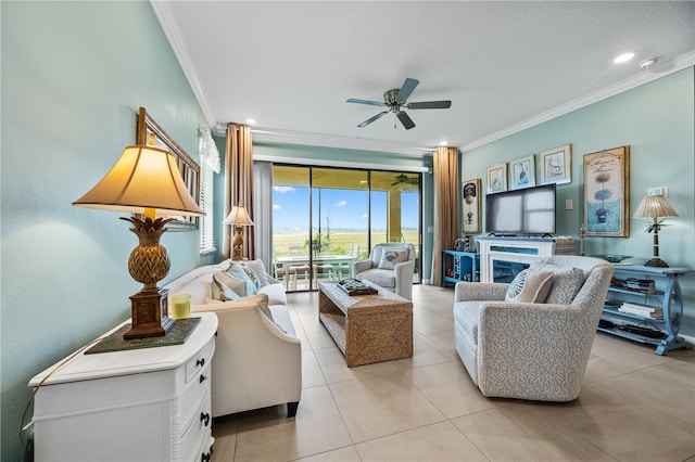 living area featuring ceiling fan, a textured ceiling, crown molding, and light tile patterned flooring