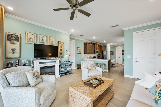 living room featuring ornamental molding, light tile patterned flooring, and recessed lighting