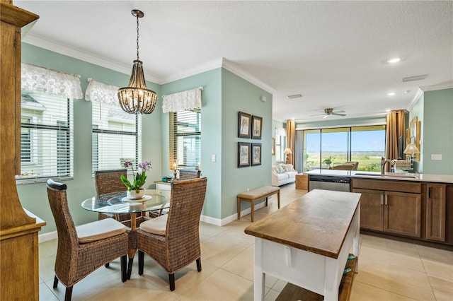 dining room with baseboards, visible vents, light tile patterned flooring, crown molding, and ceiling fan with notable chandelier