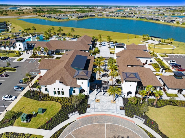 birds eye view of property with a water view and a residential view