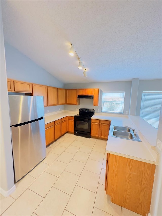 kitchen featuring black electric range oven, sink, vaulted ceiling, stainless steel fridge, and light tile patterned flooring