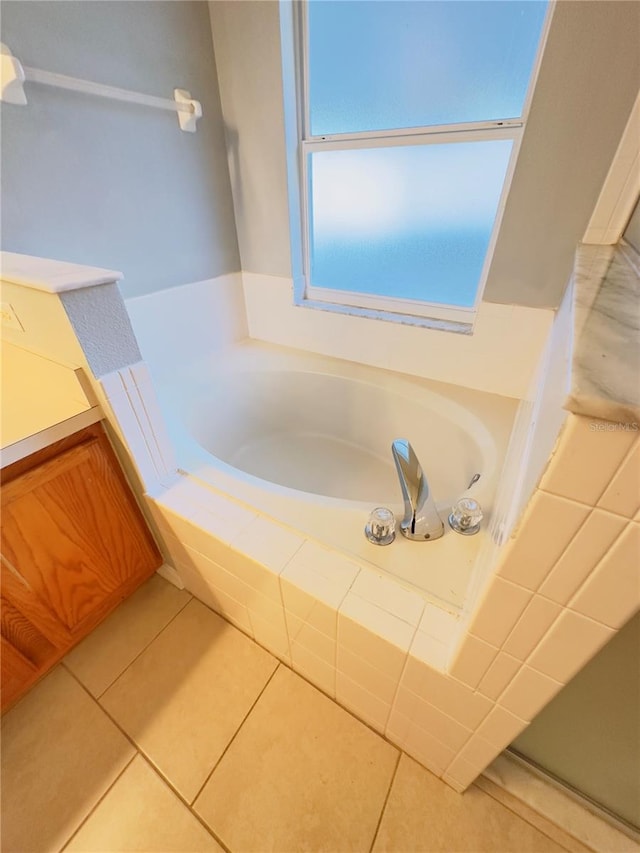 bathroom featuring tile patterned flooring and tiled tub