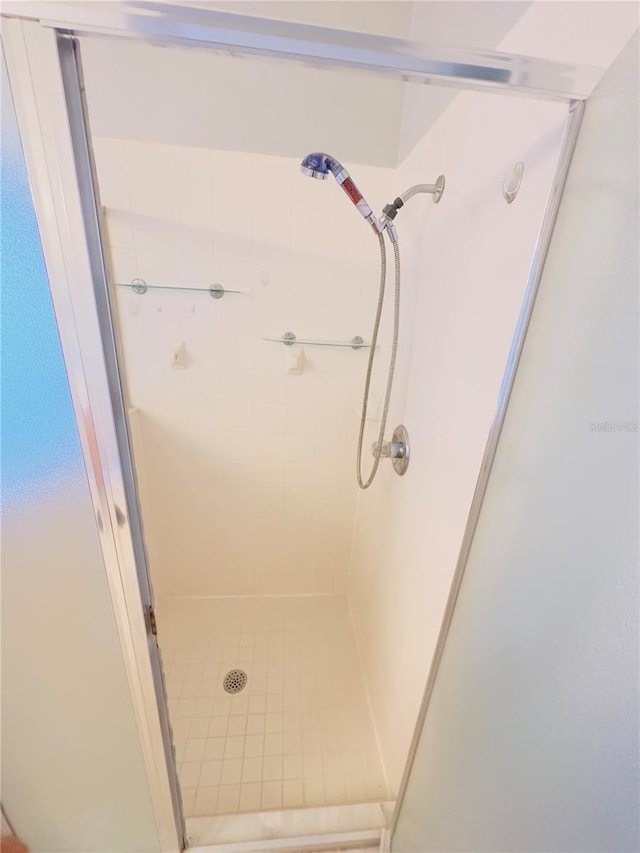 bathroom with a shower with door