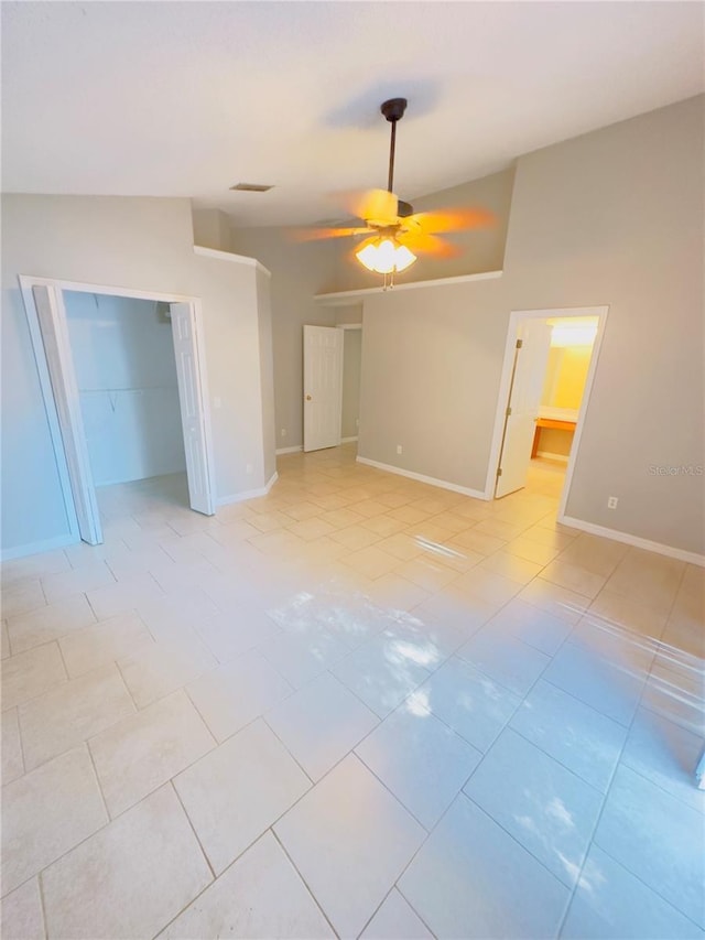 tiled spare room featuring ceiling fan and lofted ceiling