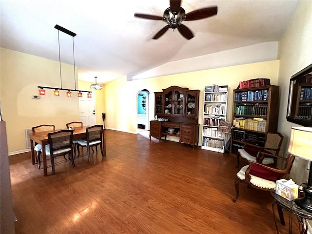 dining space with ceiling fan, dark hardwood / wood-style flooring, and lofted ceiling