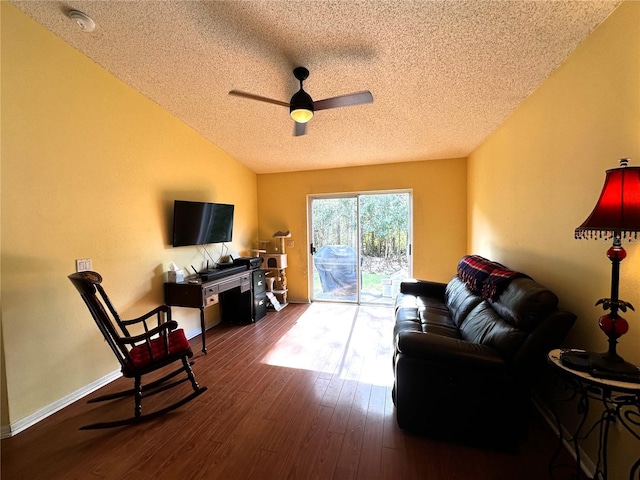 living room with ceiling fan, dark hardwood / wood-style flooring, and a textured ceiling