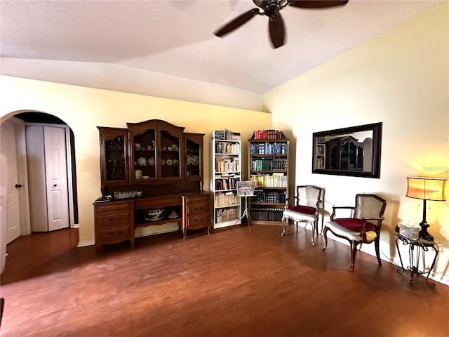 sitting room featuring dark hardwood / wood-style floors, vaulted ceiling, and ceiling fan