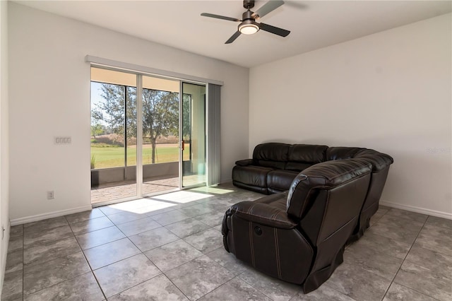 living room with ceiling fan and light tile patterned flooring