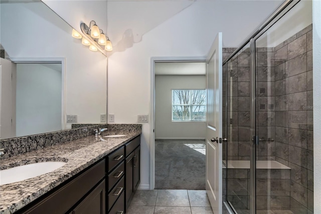 bathroom with tile patterned flooring, vanity, and a shower with shower door