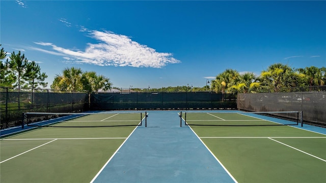 view of tennis court featuring basketball hoop