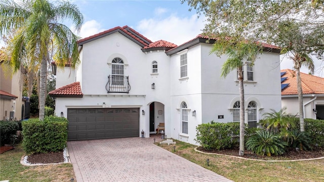 11410 Rapallo Ln, Windermere, FL 34786 - mediterranean / spanish-style house with a tile roof, stucco siding, decorative driveway, a balcony, and a garage