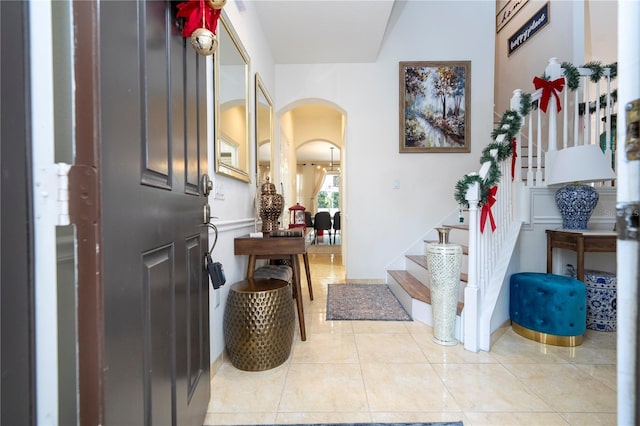 11410 Rapallo Ln, Windermere, FL 34786 - foyer featuring arched walkways, stairway, and light tile patterned flooring