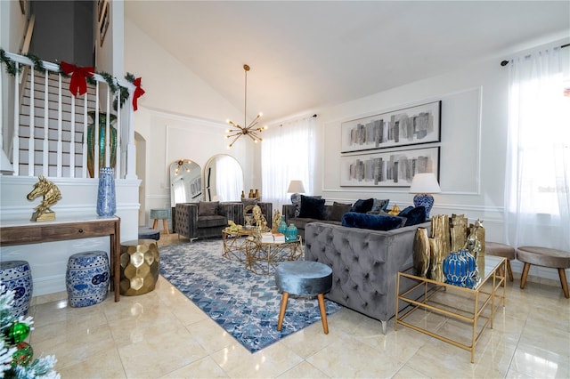 11410 Rapallo Ln, Windermere, FL 34786 - tiled living room with arched walkways, a chandelier, and lofted ceiling