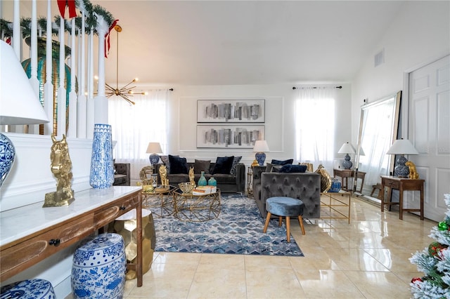 living room with a notable chandelier and vaulted ceiling