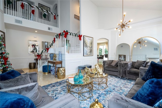 living room with high vaulted ceiling and a notable chandelier