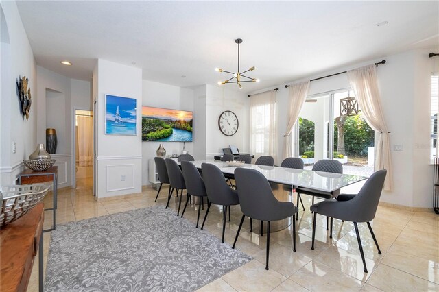 tiled dining space featuring a chandelier