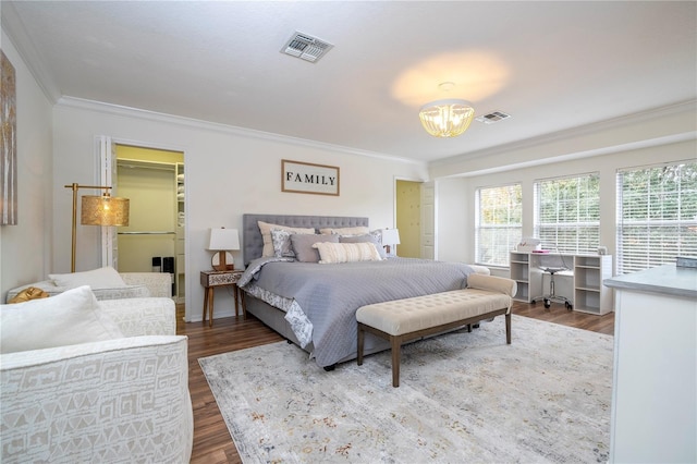 11410 Rapallo Ln, Windermere, FL 34786 - bedroom featuring crown molding, a chandelier, wood finished floors, and a walk in closet