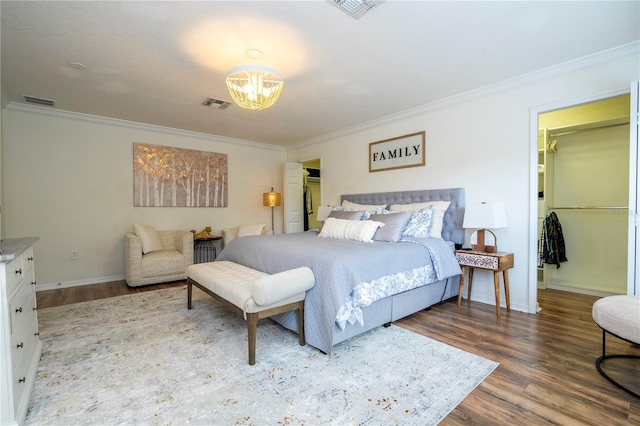 11410 Rapallo Ln, Windermere, FL 34786 - bedroom featuring ornamental molding, a spacious closet, wood finished floors, a chandelier, and a closet