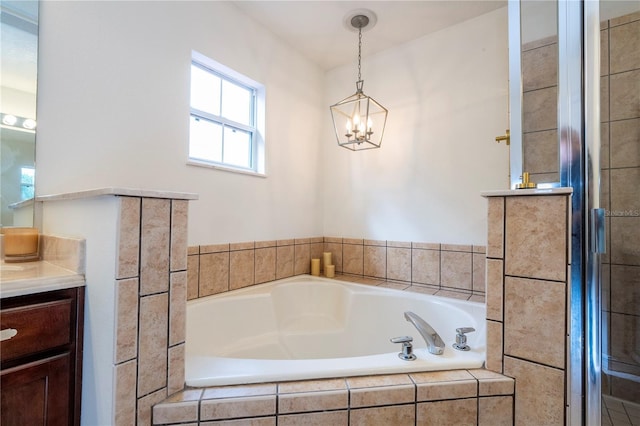 bathroom with a chandelier, shower with separate bathtub, and vanity