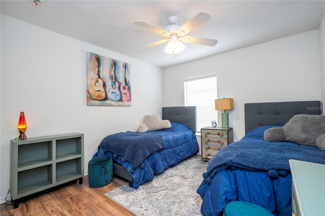 bedroom with ceiling fan and hardwood / wood-style floors