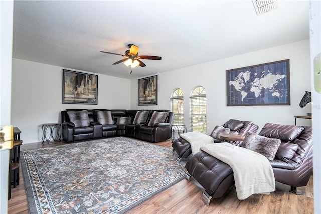 living room with ceiling fan and hardwood / wood-style flooring