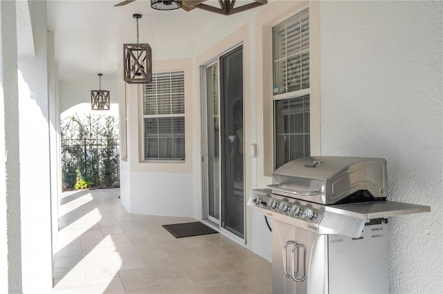 view of patio with ceiling fan and a grill