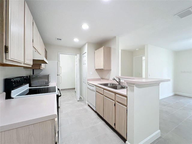 kitchen featuring light brown cabinetry, dishwasher, stove, and sink