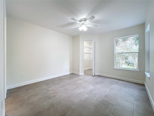 empty room featuring a textured ceiling and ceiling fan