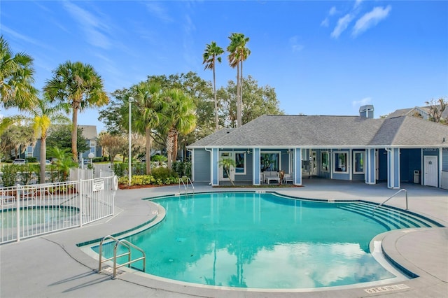 view of swimming pool with a community hot tub and a patio