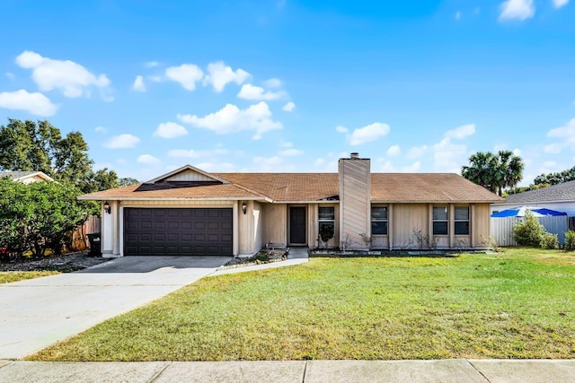 ranch-style house featuring a garage and a front lawn