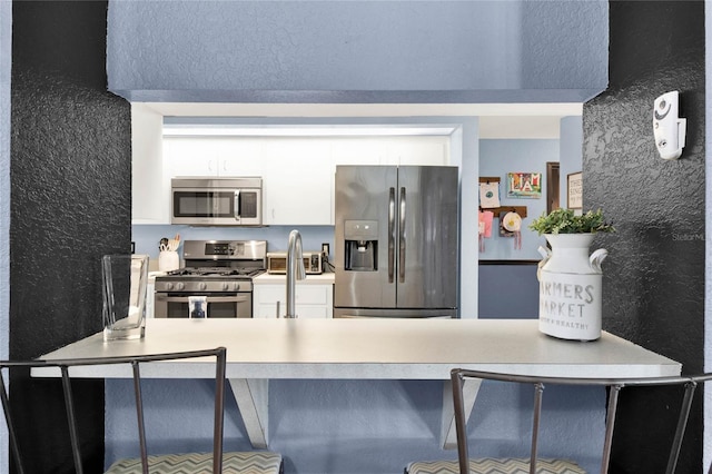 kitchen with stainless steel appliances and white cabinetry