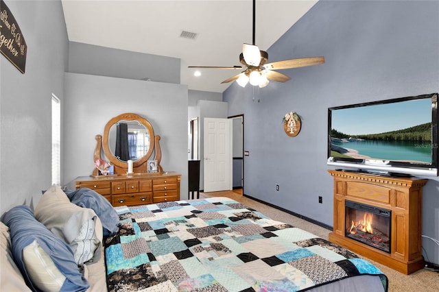 carpeted bedroom featuring ceiling fan and high vaulted ceiling