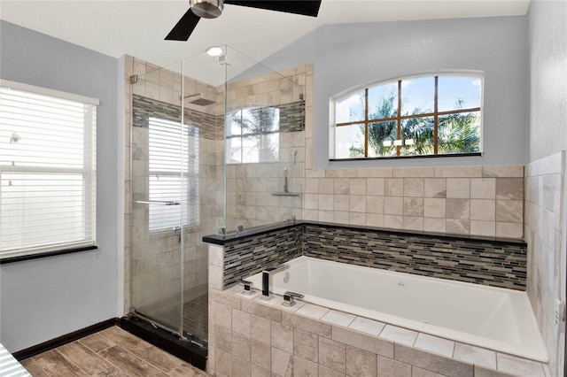 bathroom featuring ceiling fan, a healthy amount of sunlight, independent shower and bath, and vaulted ceiling